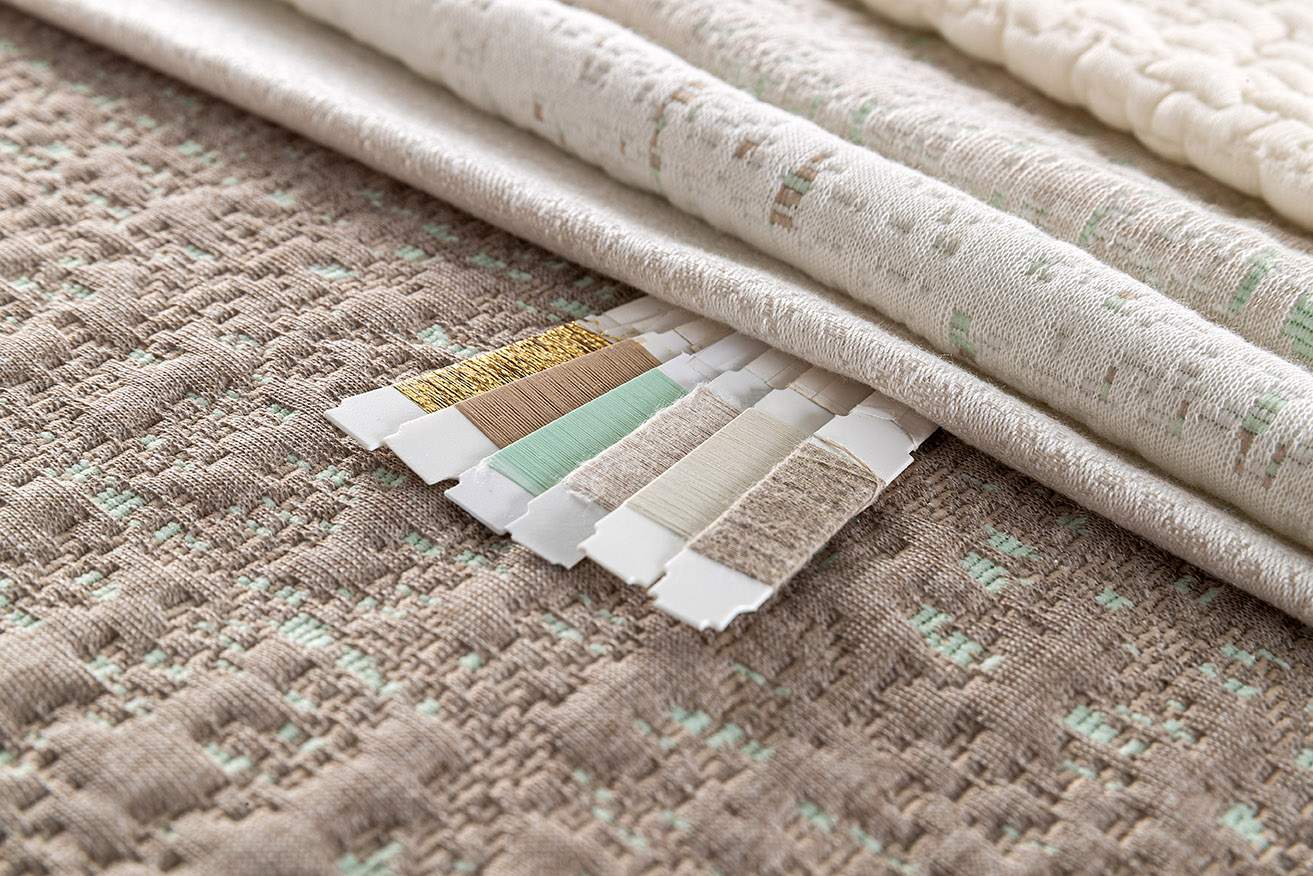 Close-up of premium quiet luxury beige soft knitwear and fabrics